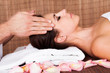 Beautiful young woman getting face massage