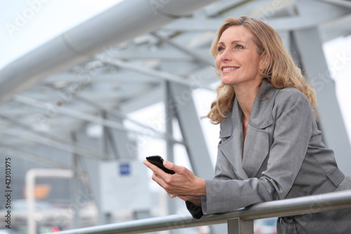 Photo: Businesswoman with mobile phone Businesswoman with mobile phone