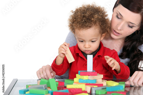 Photo: Woman and child playing with wooden blocks Woman and child playing with wooden blocks