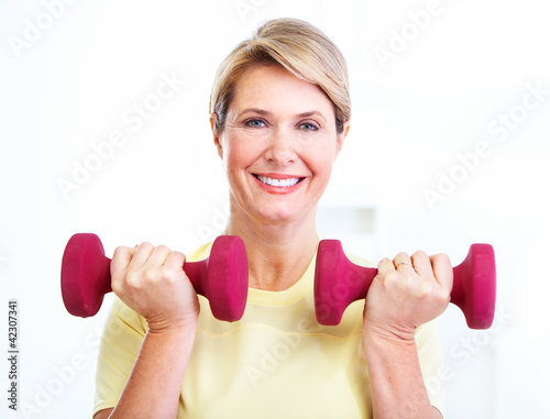 Photo: Senior woman doing fitness. Senior woman doing fitness.