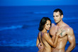 Couple hugging in ocean