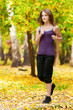 Photo: A young girl running in autumn park A young girl running in autumn park