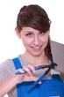 handywoman using pliers on a tile