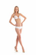 A young Caucasian woman posing in a white swimsuit
