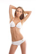 A young Caucasian woman posing in a white swimsuit