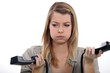 Stressed woman holding two telephones