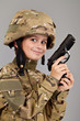 Young boy dressed like a soldier with a gun