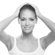 A young Caucasian woman holding her own head