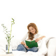 A young Caucasian woman relaxing in a white modern interior