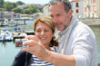 Senior couple taking picture of themselves in touristic city