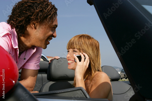 Photo: Couple by convertible car Couple by convertible car