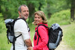 Photo: Portrait of smiling hikers in forest pathway Portrait of smiling hikers in forest pathway
