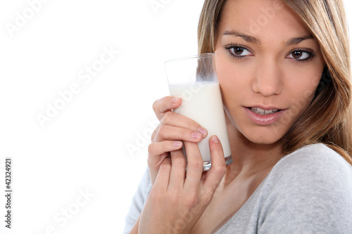 Photo: Young woman with a glass of milk Young woman with a glass of milk