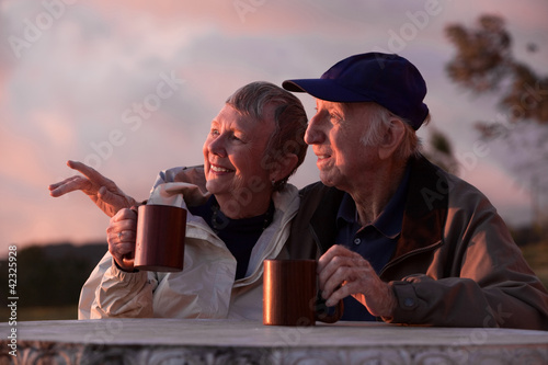 Photo: Couple Outdoors at Table Couple Outdoors at Table
