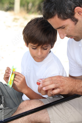 Photo: Father and son fishing together Father and son fishing together