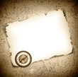 Vinatge antique compass at burned paper
