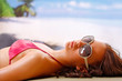 A beautiful woman taking a sun bath on a beach