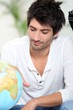 Man looking at globe