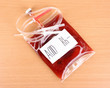 Bag of blood and infusion on wooden background