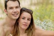 Photo: Couple sat in a remote field in summer Couple sat in a remote field in summer