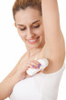young woman using an antiperspirant, white background