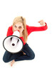 Photo: yelling young woman with megaphonesnd raised fist yelling young woman with megaphonesnd raised fist