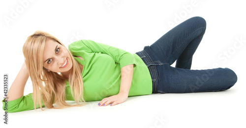 Photo: happy young woman lying on the floor, full length happy young woman lying on the floor, full length