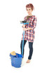 woman with blue bucket cleaning floor, full length