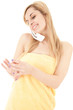 portrait of cute young woman in towel using mobile phone