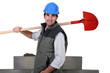 A mason holding a shovel.
