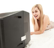 young woman lying on the floor and watching television