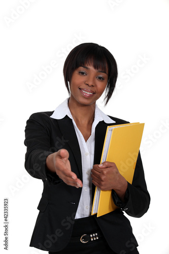 Photo: black businesswoman holding filer black businesswoman holding filer