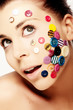 Beautiful woman with buttons on her face