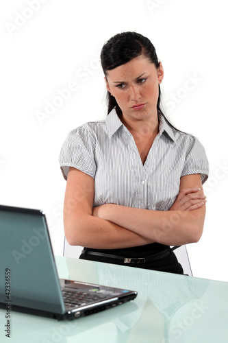 Photo: Female office worked looking annoyed Female office worked looking annoyed