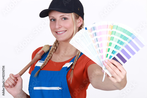 Photo: craftswoman painter holding a color chart craftswoman painter holding a color chart