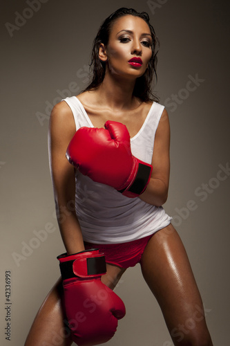 Photo: Seductive woman boxer glistening with sweat Seductive woman boxer glistening with sweat