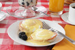 Eggs benedict with fruit cocktail
