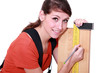Woman marking plank of wood using set-square
