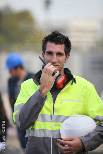 Photo: Construction worker with a walkie talkie Construction worker with a walkie talkie
