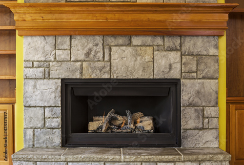 Photo: Natural Gas Insert Fireplace with Stone and Wood Natural Gas Insert Fireplace with Stone and Wood