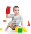 little child playing with building blocks