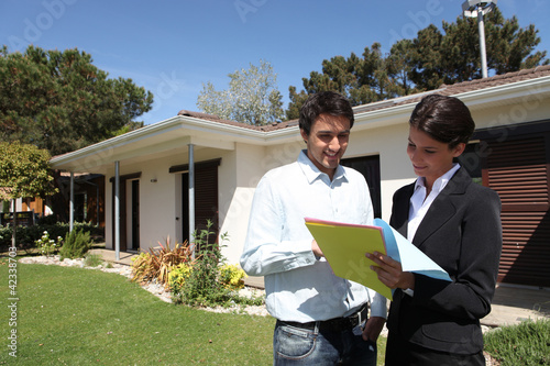 Photo: realtors in front of a house realtors in front of a house