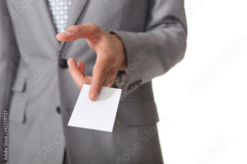 Foto: Confident businessman handing out card Confident businessman handing out card