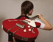 A young boy standing with his back with bass
