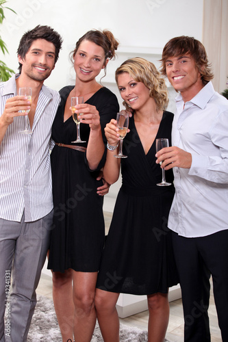 Photo: Two young couples drinking champagne Two young couples drinking champagne