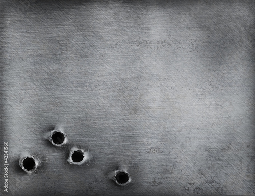 Photo: metal background with bullet holes metal background with bullet holes
