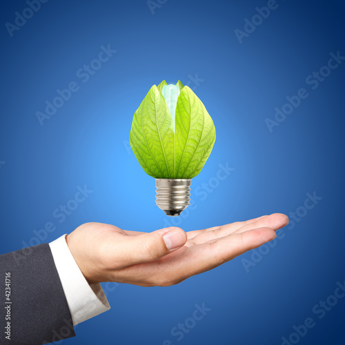 Photo: Concept of energy saving light bulbs on Business hand Concept of energy saving light bulbs on Business hand