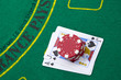 Ace of hearts and black jack with red poker chips