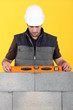 craftsman making measurements with level