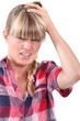 Young woman rubbing her head
